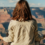 Woman meditating on a mountaintop